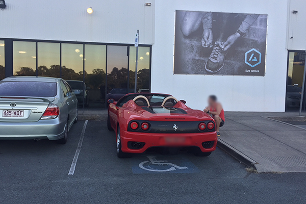 Article image for Ferrari parked in designated disabled parking spot used by elderly gym users