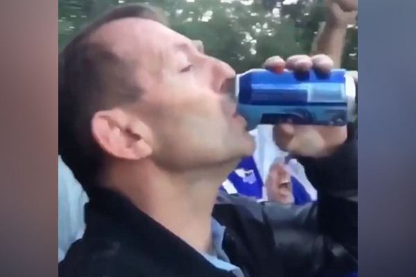 Article image for WATCH | Former PM knocks back a beer at the footy