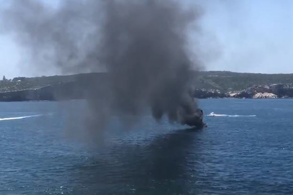 Boat bursts into flames with four people on board