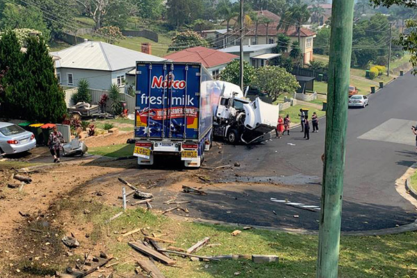 Article image for Delivery truck flies off highway and crashes into residential street