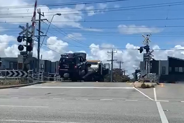 WATCH | Tow truck narrowly avoids being cleaned up by train