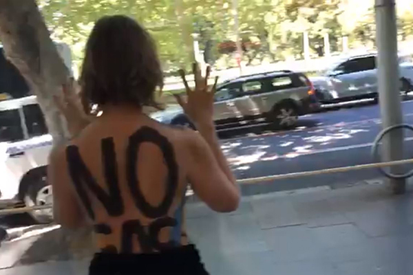 Article image for Extinction Rebellion protester calls in after gluing herself to CBD building