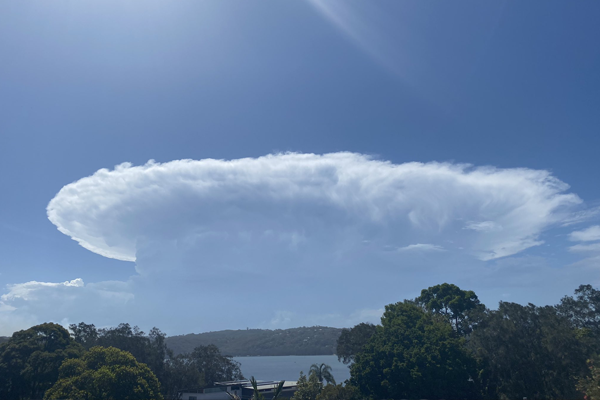 Wild weather on its way to Sydney as smoke haze hovers over the north