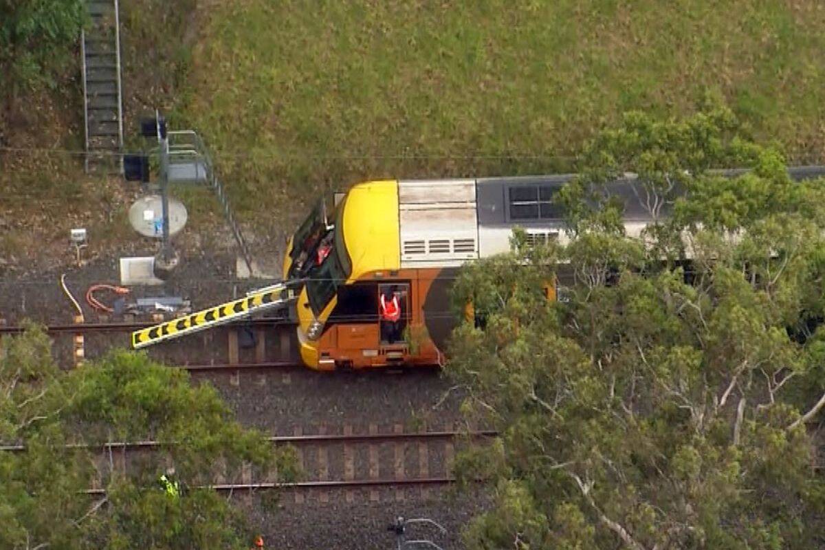 Article image for Two trains trapped after power lines fell onto the tracks in Sydney south-west