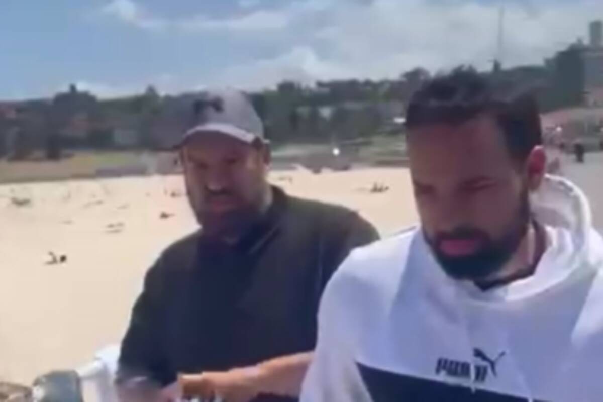 Article image for WATCH: Men taking down hostage posters at Bondi Beach